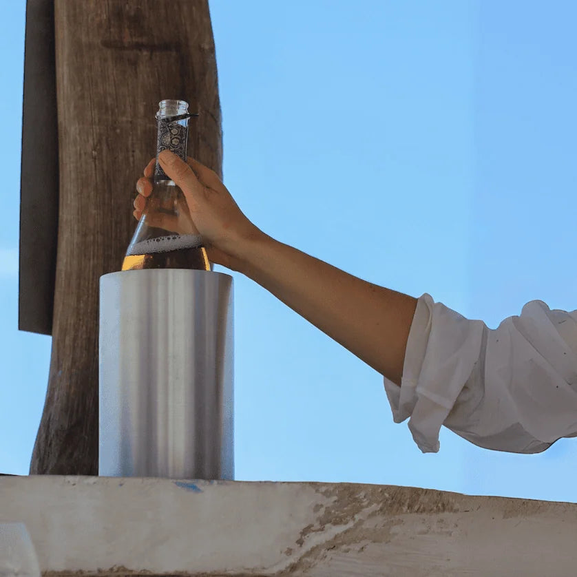 Coolenator classic silver design wine cooler with a bottle of wine someone holding the bottle with their hand