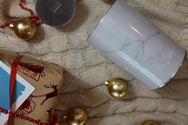 A Coolenator wine cooler on a Christmas table with a chilled bottle of wine