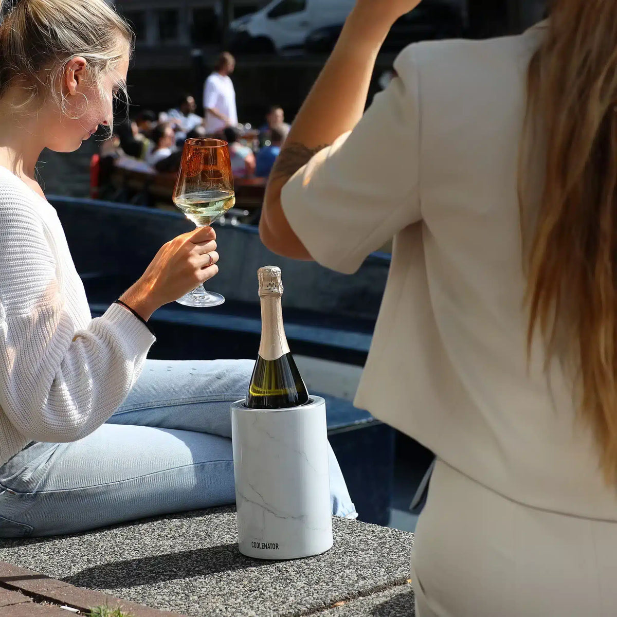 Coolenator and wine glasses beside an Amsterdam canal